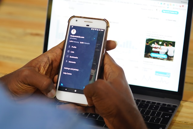 A user viewing their Twitter menu page on a smartphone.