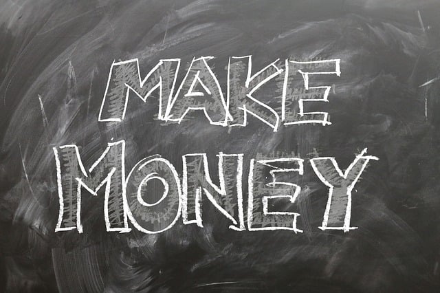 A blackboard containing the phrase “Make Money”  illustrated with white chalk.