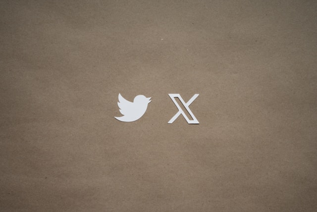 The old Twitter and the new X logo side-by-side on a brown background.