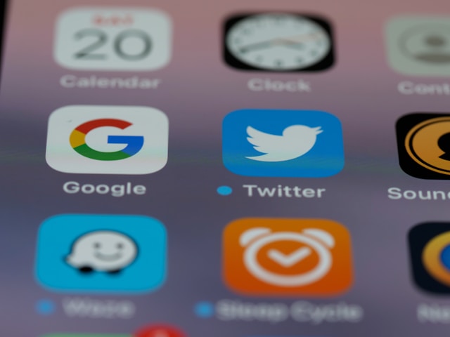 An iPhone screen showing different app icons focusing on Gmail and Twitter.